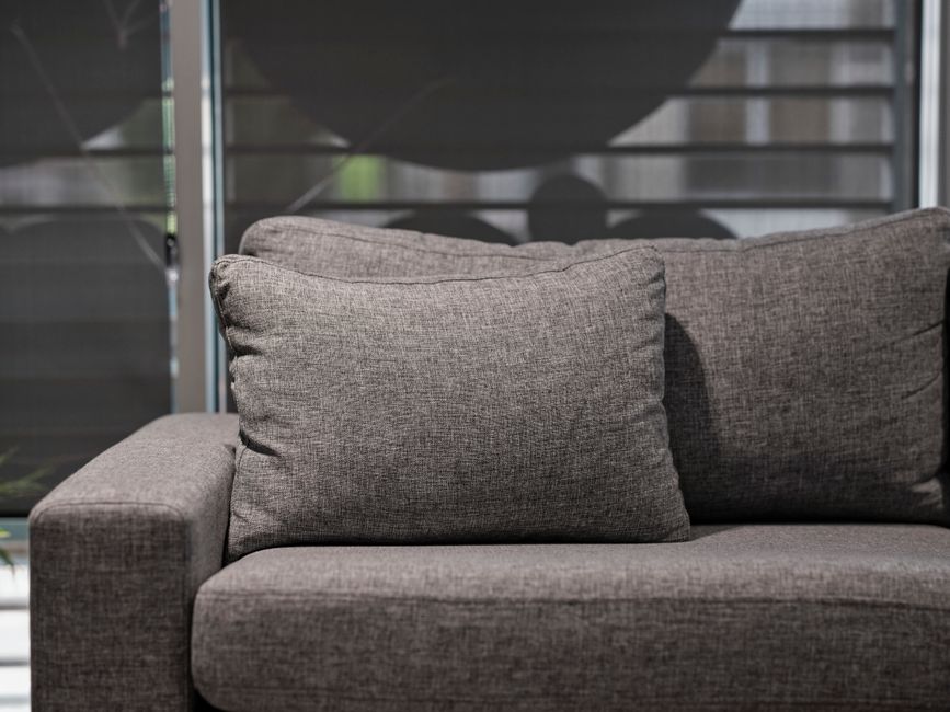 Detailed upholstery cleaning process on a fabric sofa